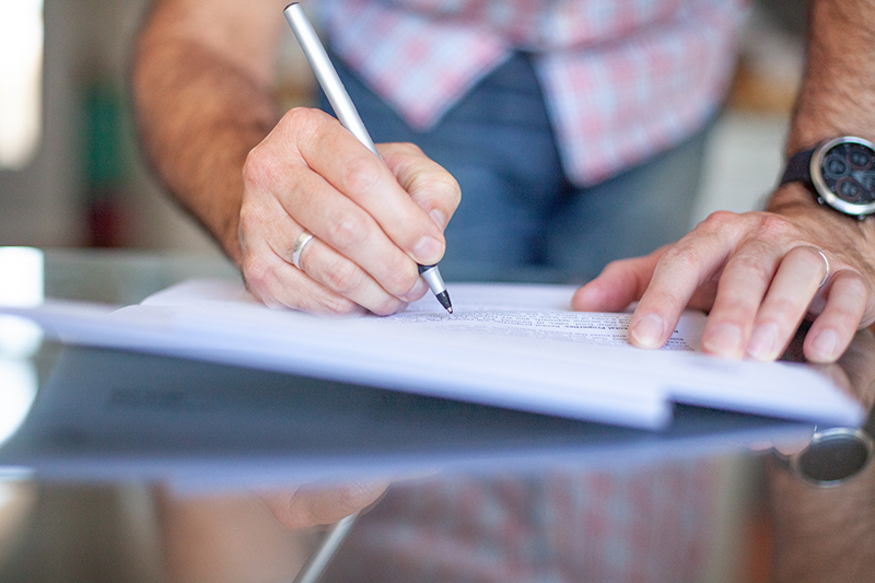 man signing paperwork